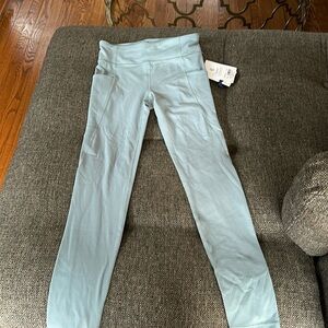 Girls green leggings size XL/14  two pockets on the side of the legs.